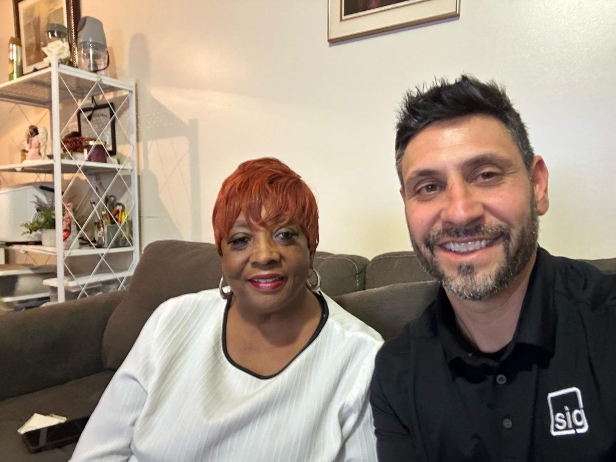 A Sahlman Insurance Group agent meeting with a client at home